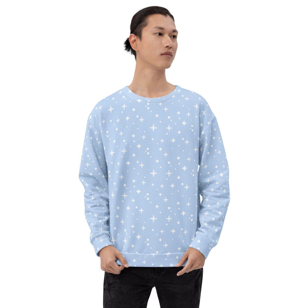 Person wearing a light blue sweatshirt with star patterns on a white background