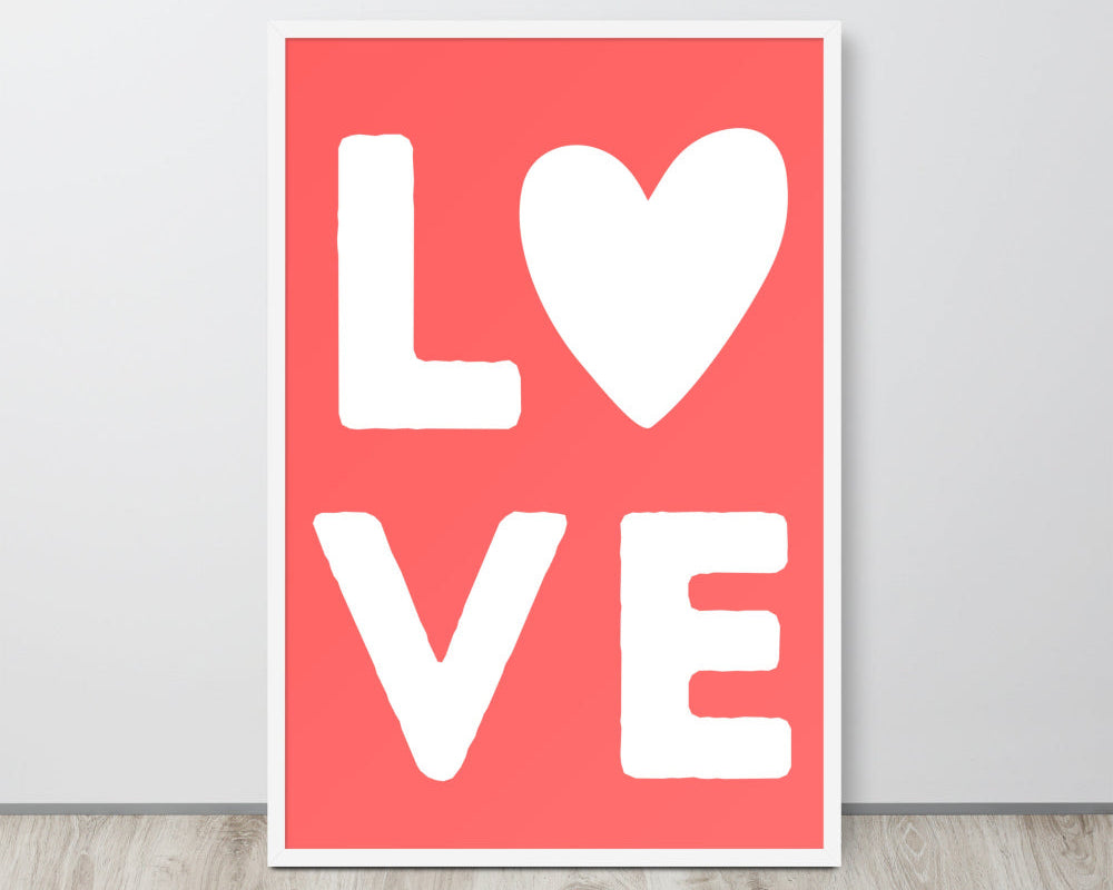 Poster with 'LOVE' text on a red background, leaning against a white wall.