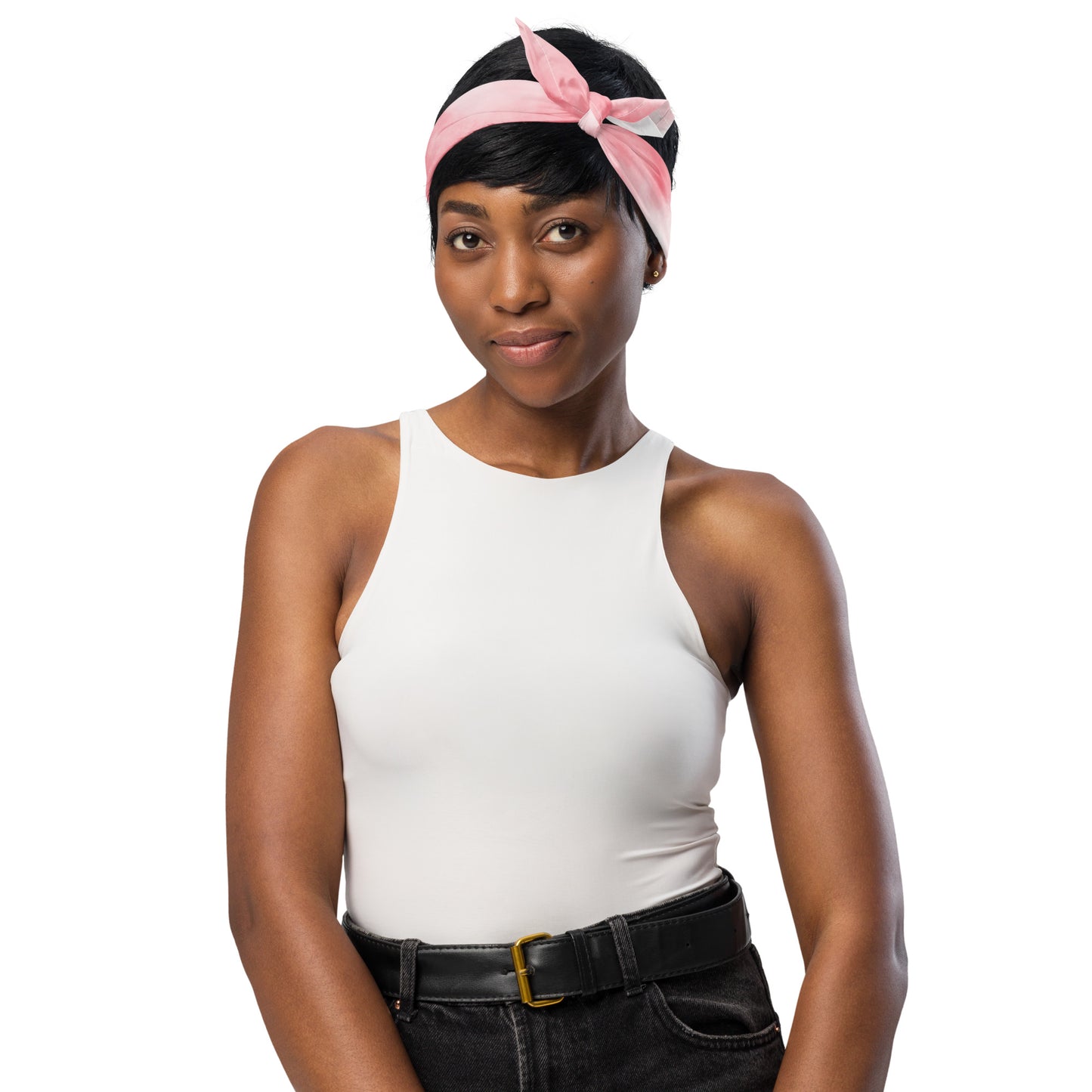 Woman wearing a white tank top and black pants with a pink headband on a white background
