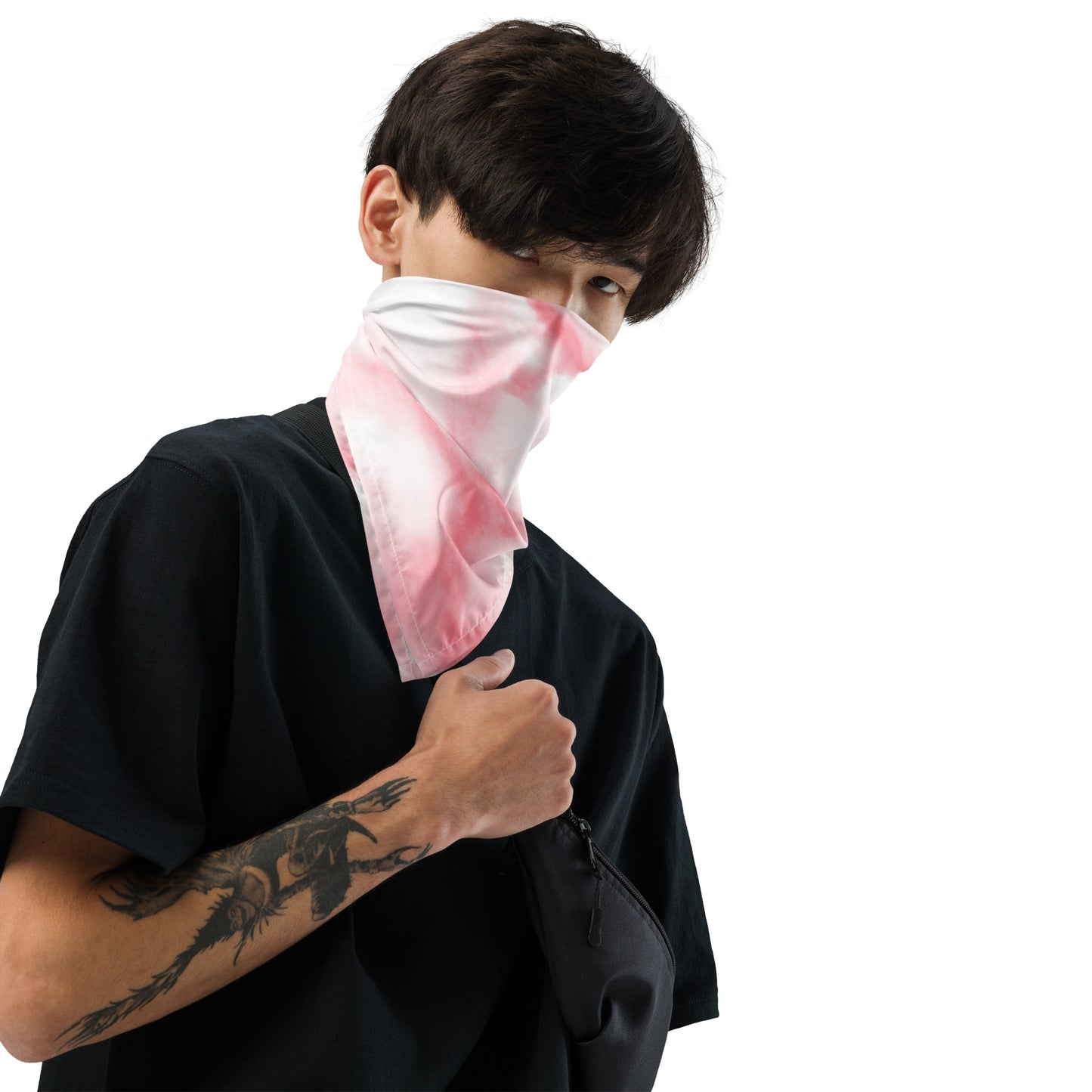 Person wearing a black outfit with a pink and white patterned face covering on a white background
