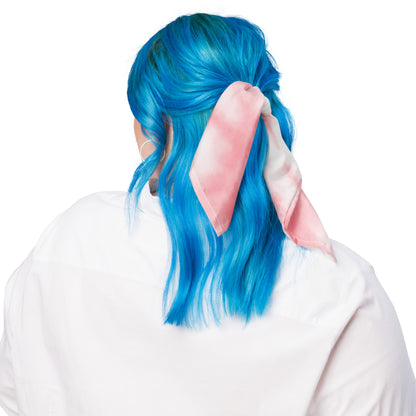 Person with blue hair wearing a pink bunny ear headband on a white background